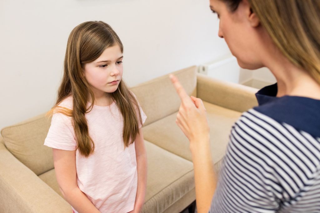 mother scolding her daughter living room