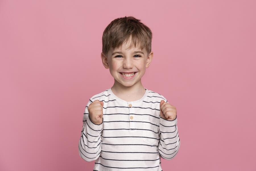smiley little boy isolated pink 1